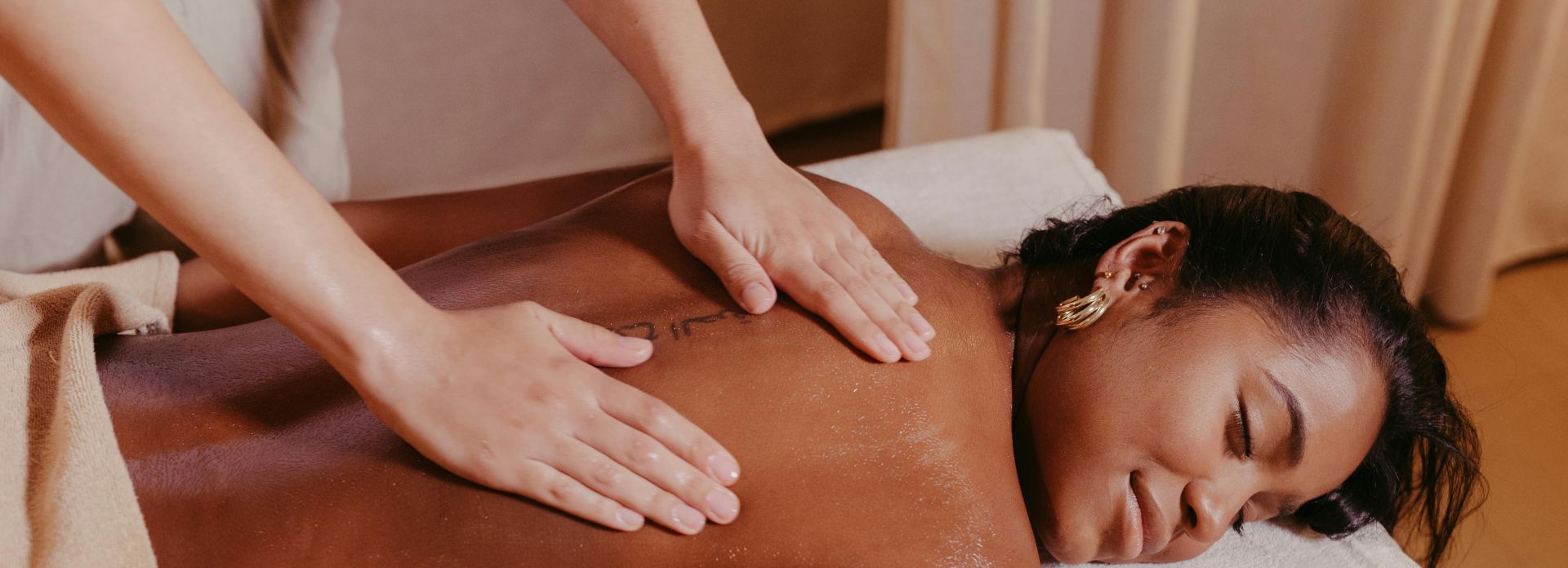 Woman Lying on a Massage Table and Getting a Massage