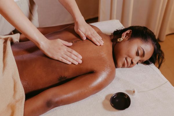 Woman Lying on a Massage Table and Getting a Massage