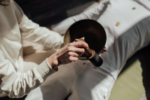 A Person Using a Mallet on a Singing Bowl